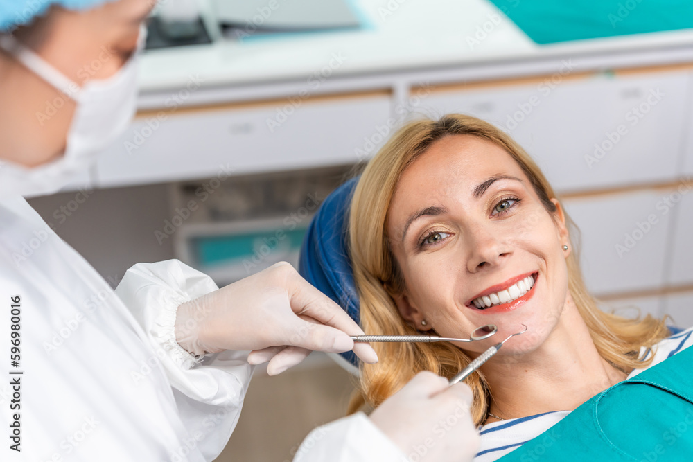 Female dentist examine tooth to Caucasian girl at dental health clinic. 