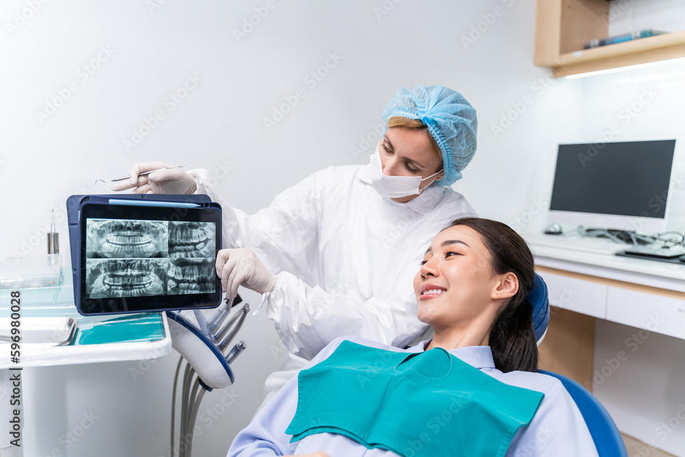 Caucasian dentist examine tooth for young girl at dental health clinic. 