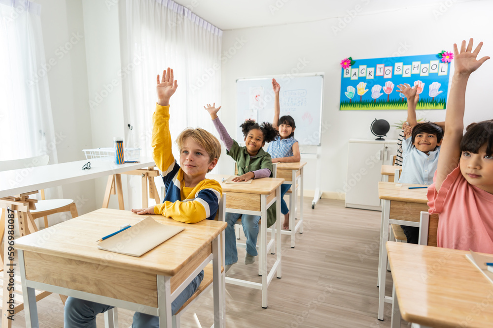 Group of student learn with teacher in classroom at elementary school. 