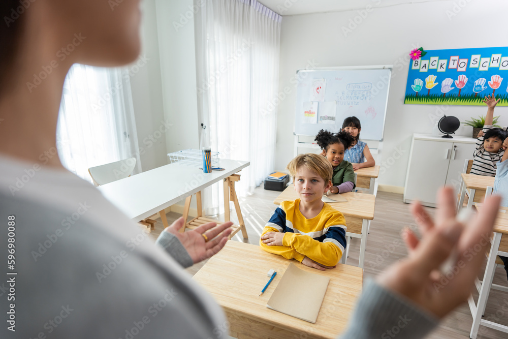 Group of student learn with teacher in classroom at elementary school. 