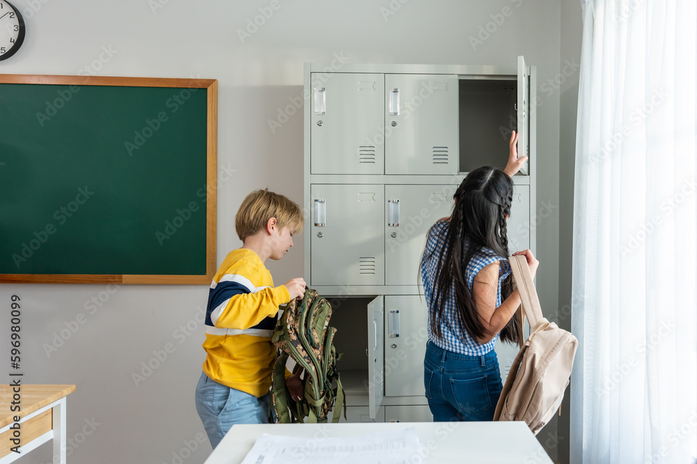 Young student leave classroom after finished study in elementary school. 