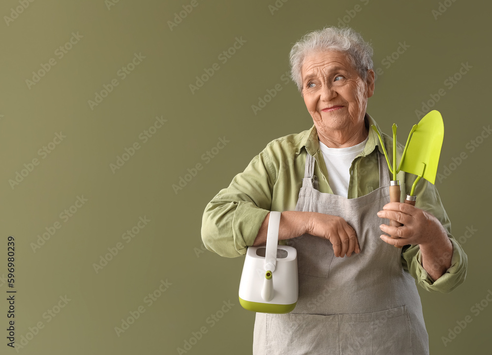 Senior gardener with tools on green background