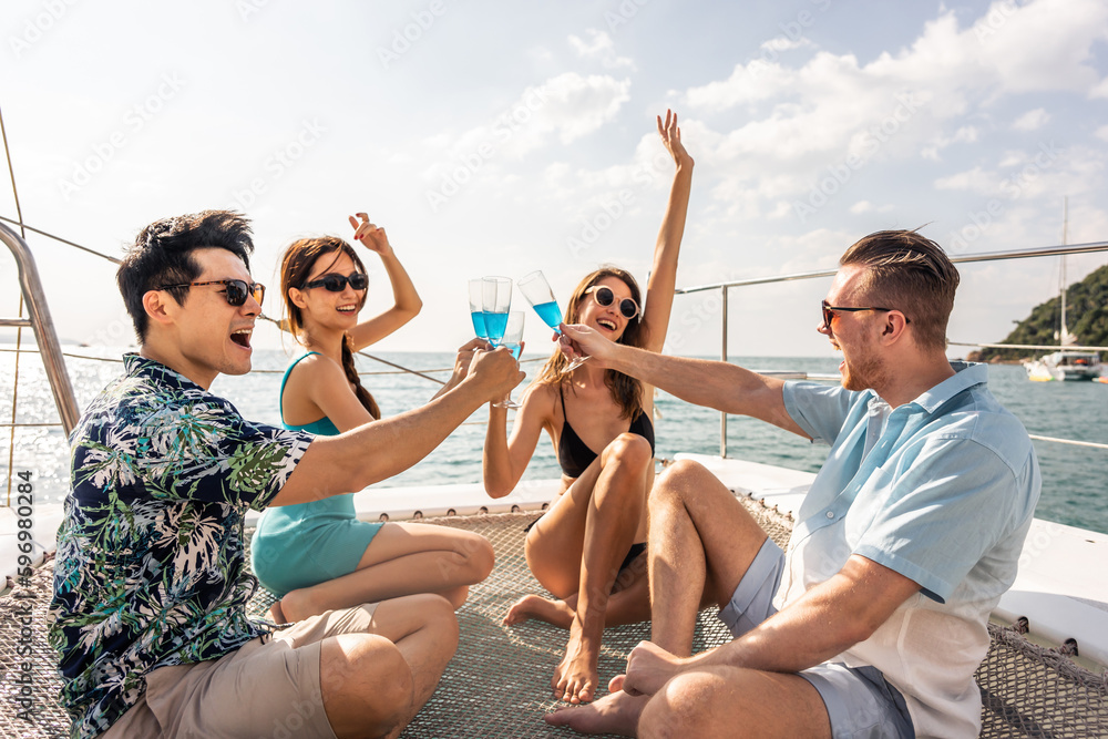 Group of diverse friends drink champagne while having a party in yacht. 