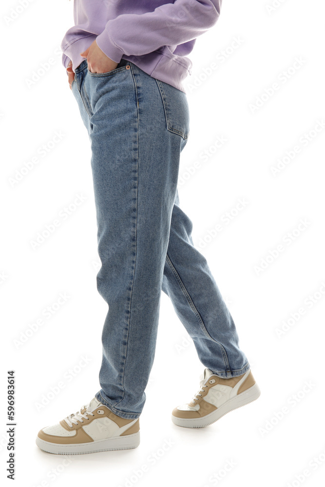 Young woman in stylish jeans on white background