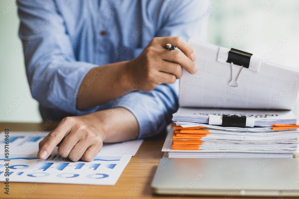 Business Documents, Auditor businessman checking working in stack of paper files for searching docum