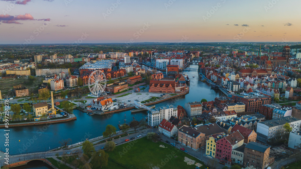 Panorama of Gdańsk with a view of the Motława River, the Old Town and the observation wheel at sunse