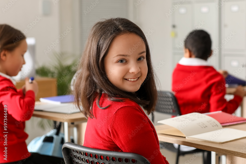 Little girl studying Chemistry lesson in science classroom, closeup