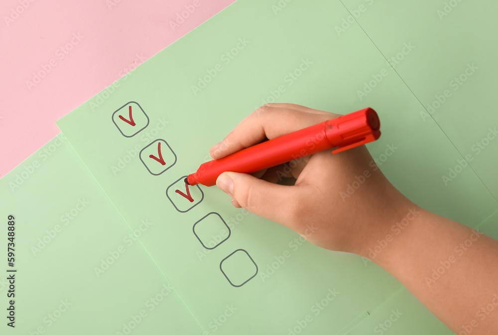 Woman marking on checklist box with red marker