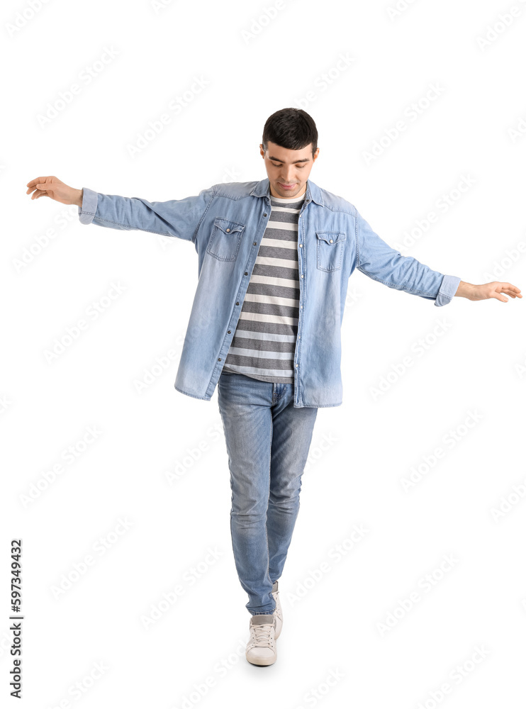 Young man balancing on white background