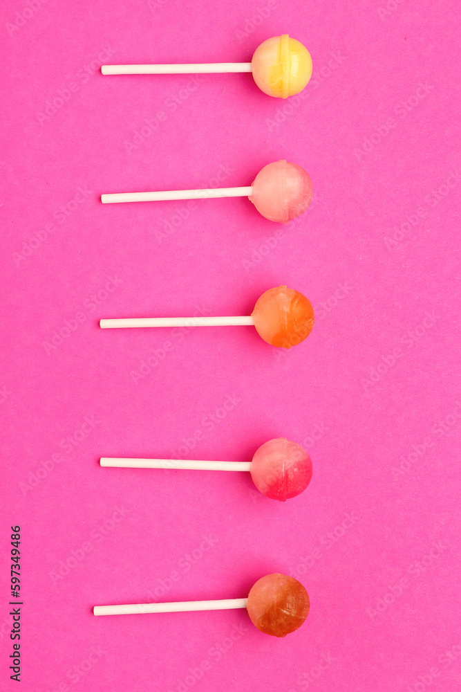 Sweet lollipops on pink background