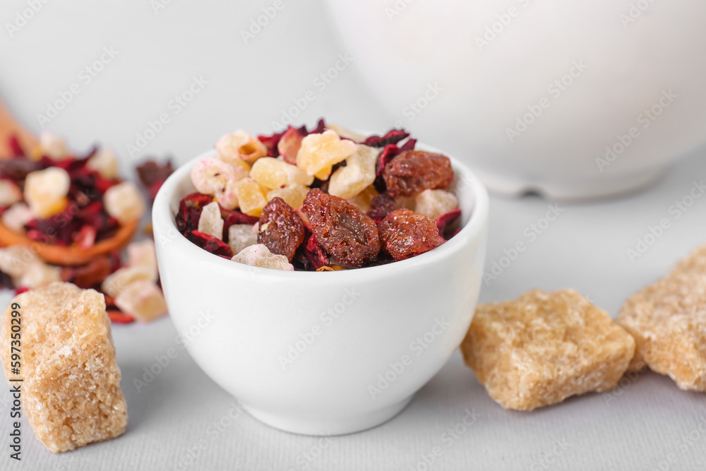 Bowl with dried fruit tea and snacks isolated on white background