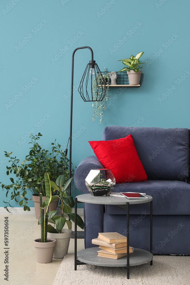 Interior of living room with sofa, table and houseplants