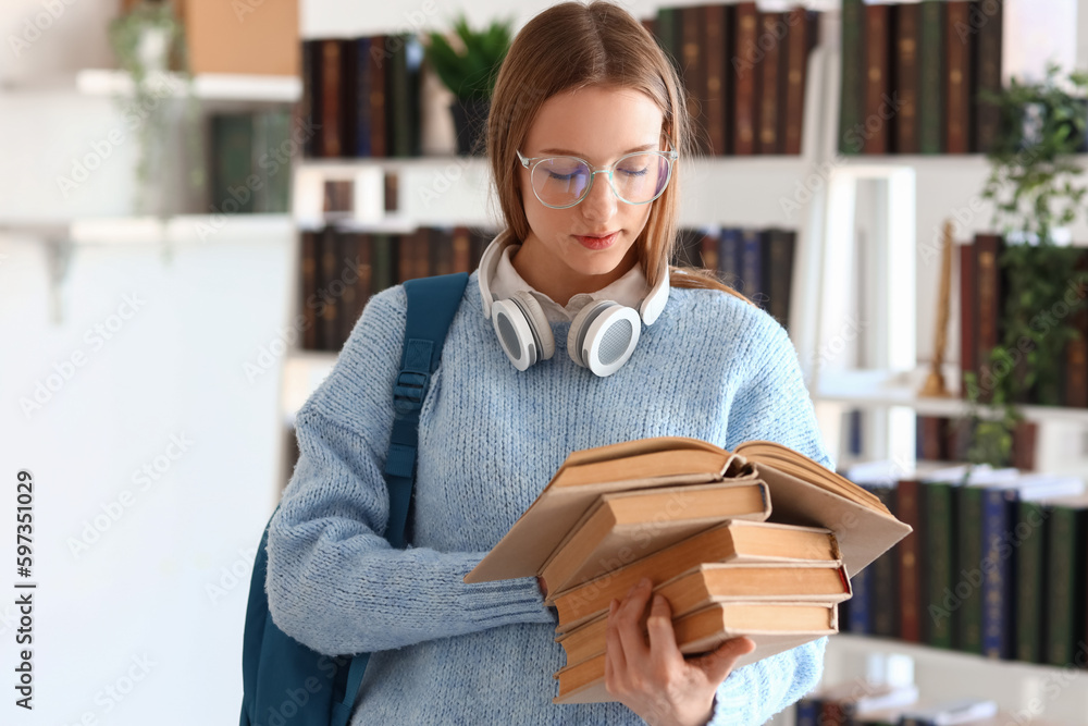 Female student with books in library