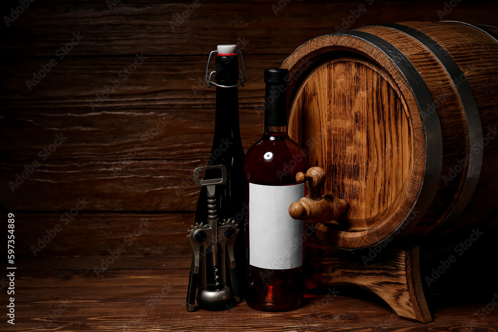 Oak barrel with bottles of wine on wooden background