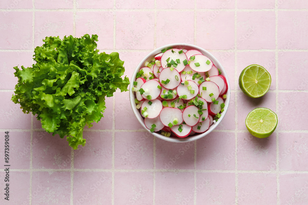 Lettuce and bowl with fresh slices of radish on pink tile background