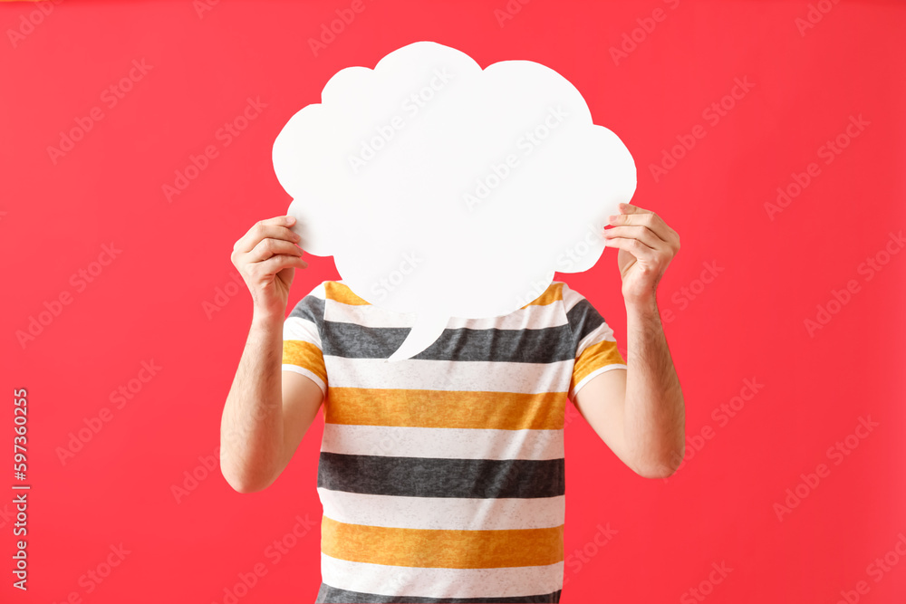 Young man with blank speech bubble on red background