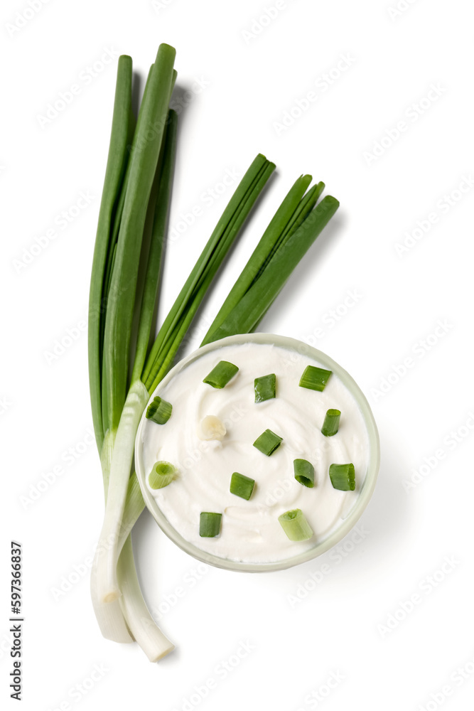 Bowl of tasty sour cream with green onion on white background