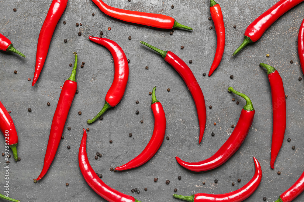 Fresh chili peppers with peppercorns on dark background