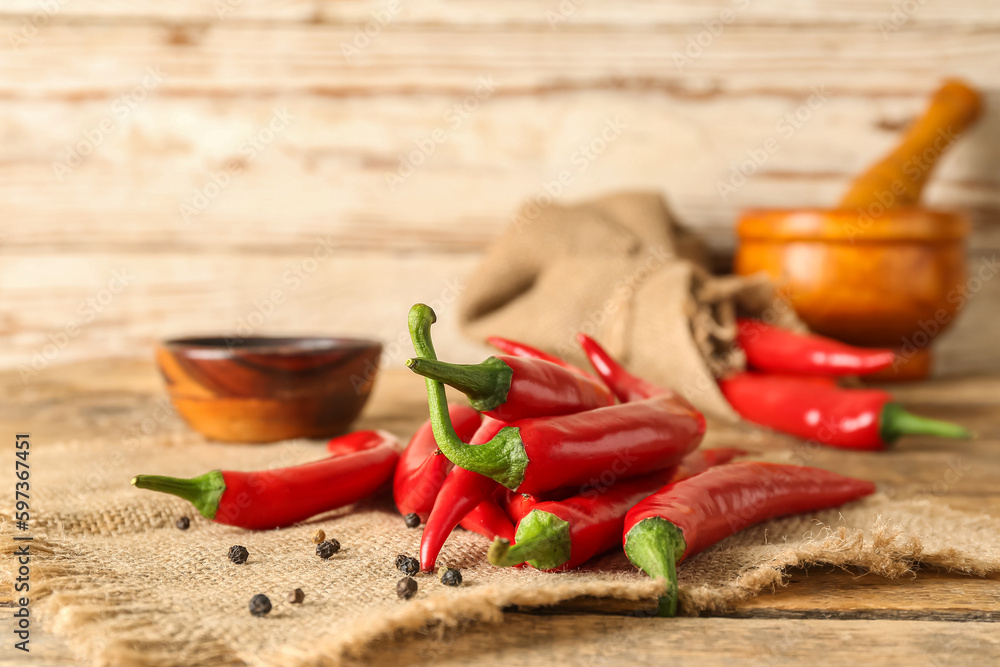 Heap of fresh chili peppers on table