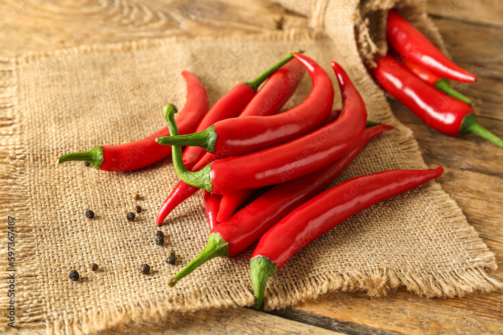 Heap of fresh chili peppers on wooden background