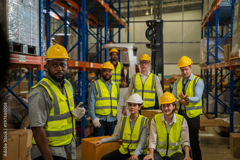 Successful warehouse team smiling happily,Cheerful logistics workers in a large distribution warehou