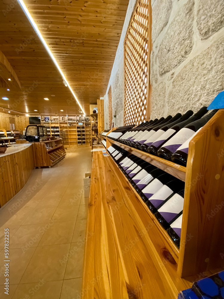 Wooden storage stand with bottles of wine in store