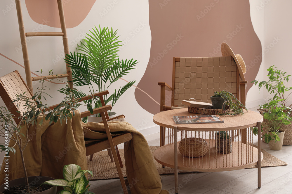 Interior of stylish living room with armchairs, houseplants and coffee table