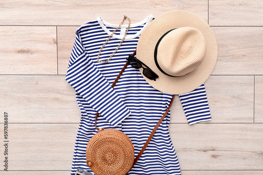 Striped dress with accessories on light wooden floor