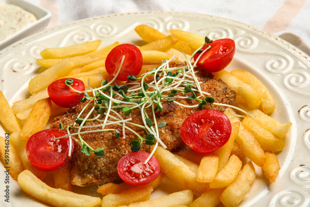 Plate of tasty fried codfish with french fries on table, closeup