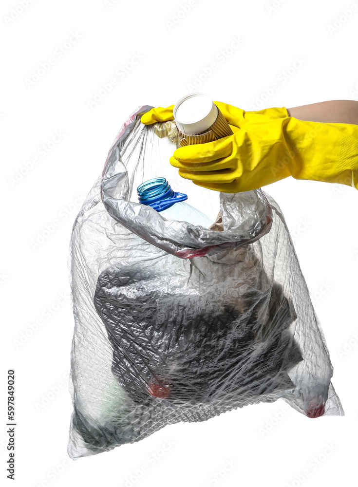 Female hands in rubber gloves putting paper cup into garbage bag isolated on white background