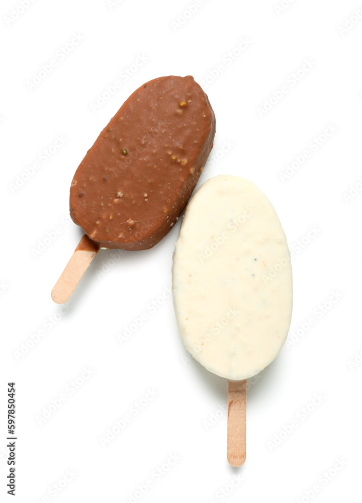 Different chocolate covered ice cream on stick against white background