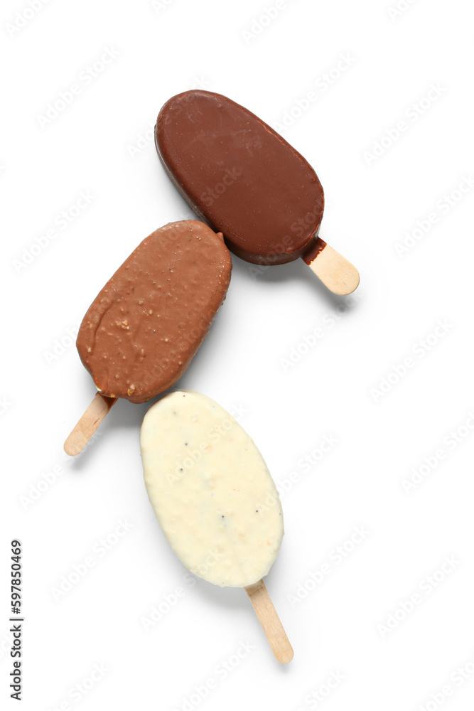 Different chocolate covered ice cream on stick against white background