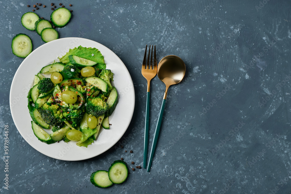 Plate of salad with vegetables on dark blue background