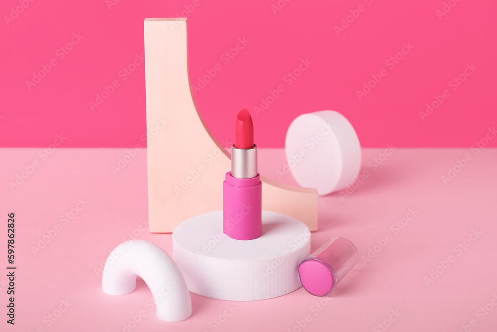 Decorative plaster podiums and lipstick on pink background