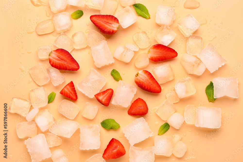 Sliced fresh strawberry with mint and ice on orange background