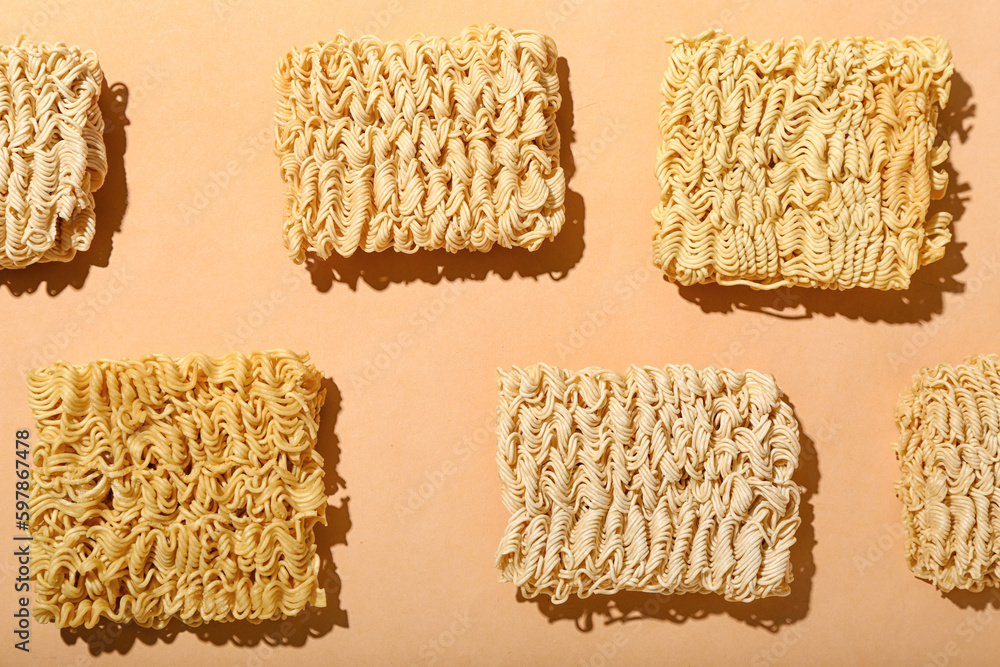 Raw instant noodles on beige background