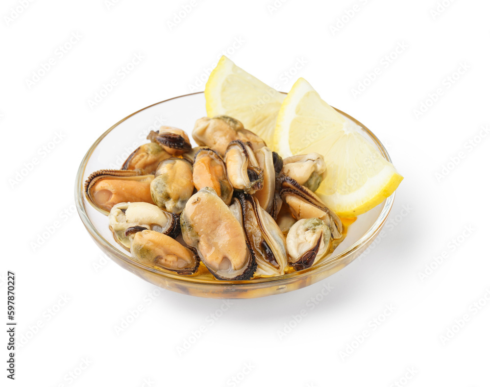 Marinated mussels with lemon slices in glass bowl on white background