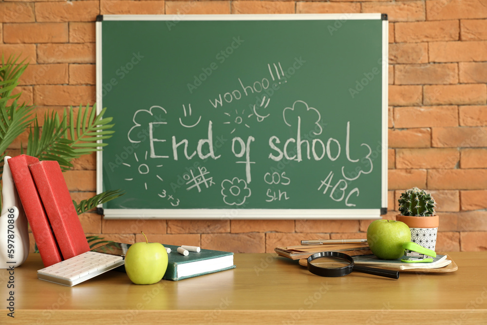 Blackboard with text END OF SCHOOL and drawings in classroom