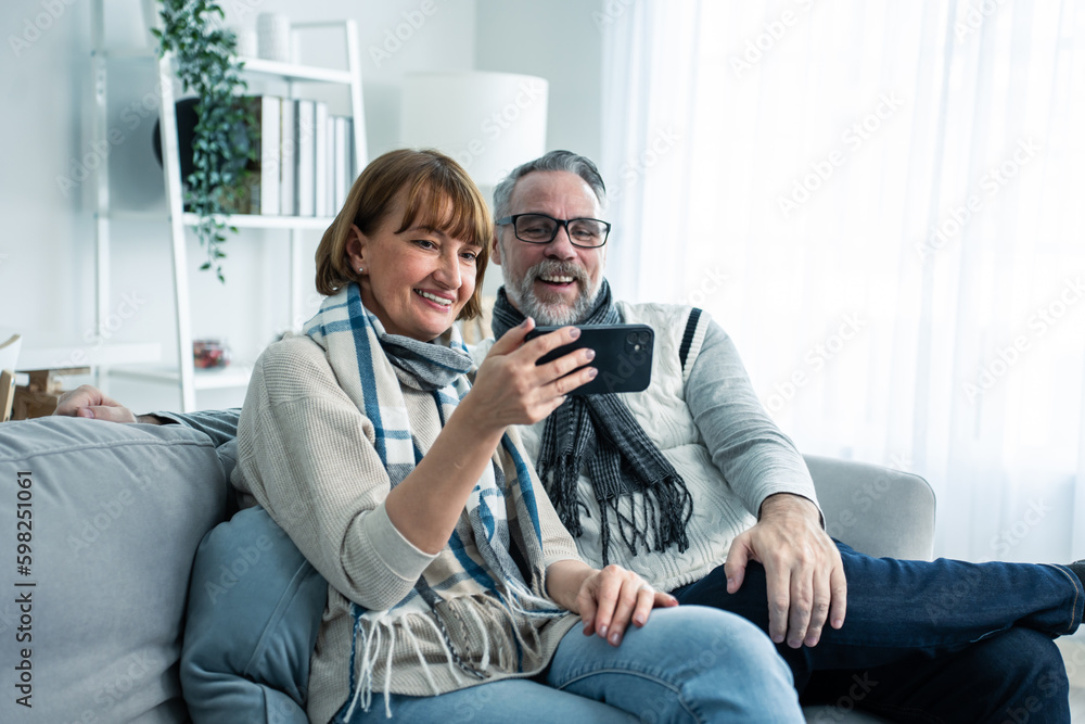 Caucasian senior couple video call with family in living room at home. 