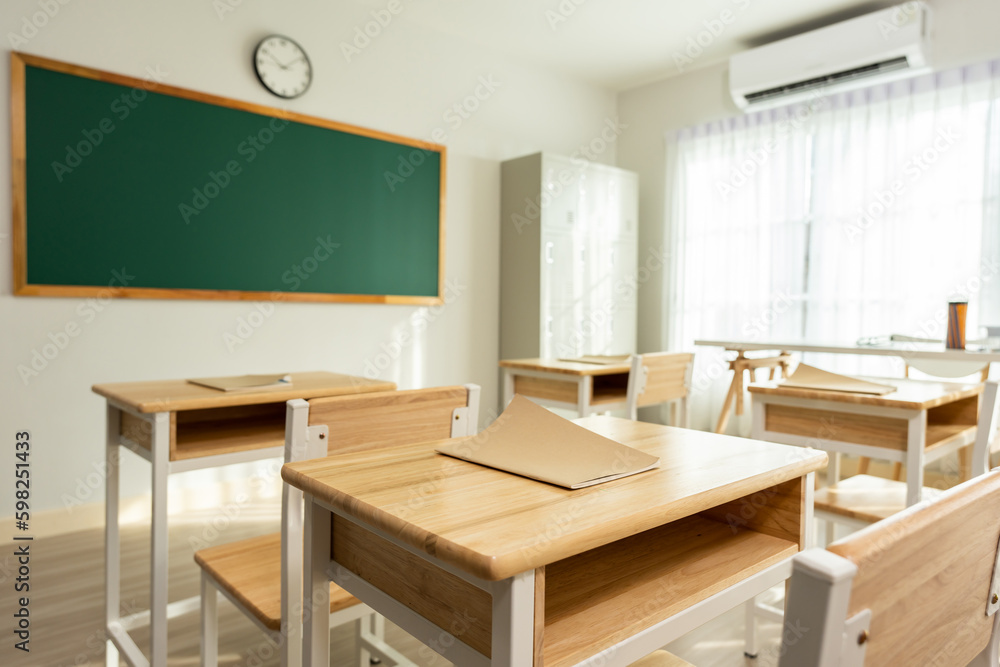 Shot of empty classroom with chairs under desks in elementary school. 