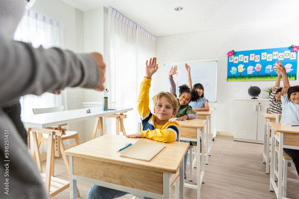 Group of student learn with teacher in classroom at elementary school. 