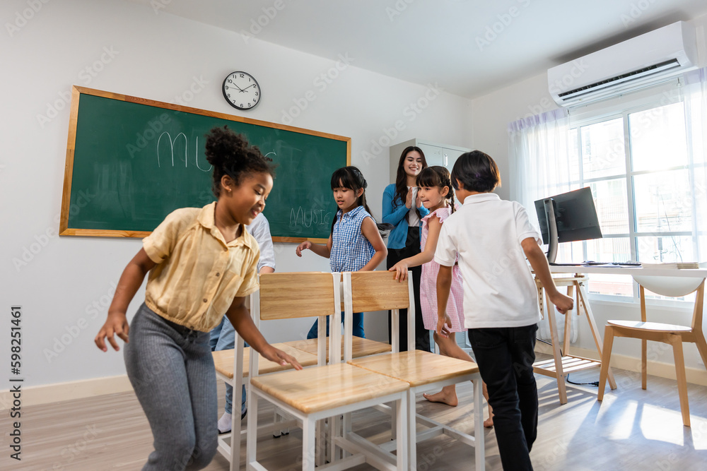 Group of student learn with teacher in classroom at elementary school. 