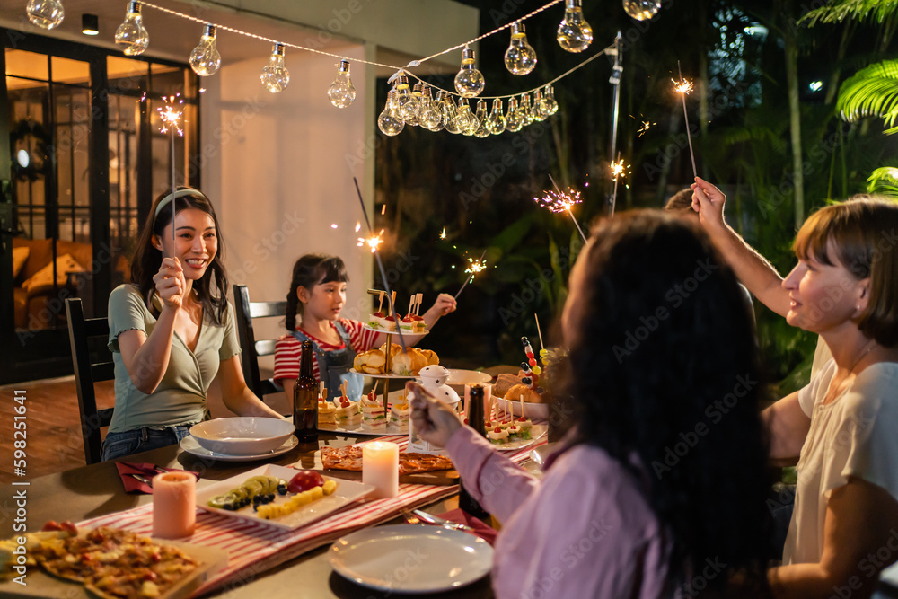 Multi-ethnic big family having fun, enjoy party outdoors in the garden. 