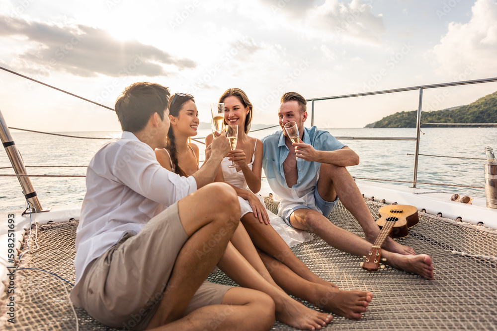 Group of diverse friends drink champagne while having a party in yacht. 