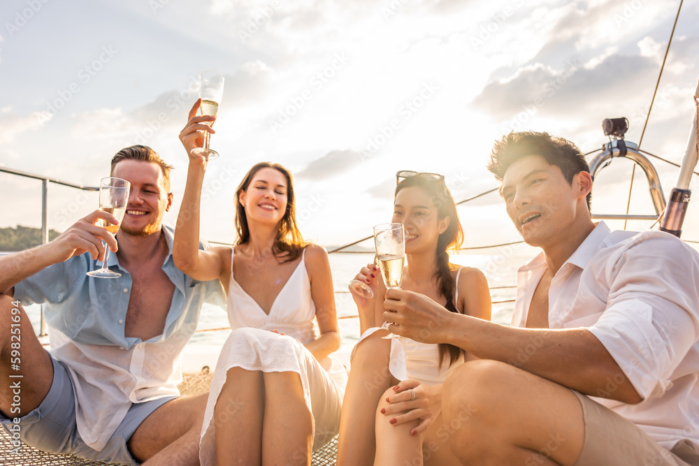 Group of diverse friends drink champagne while having a party in yacht. 