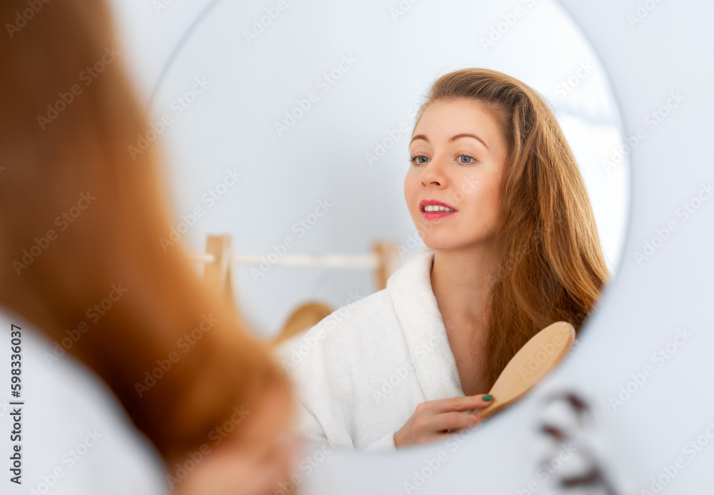 woman brushing her red hair