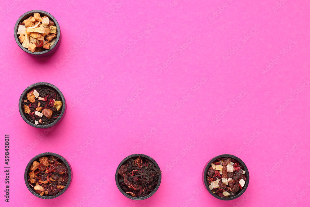 Bowls with different dried fruit tea on pink background