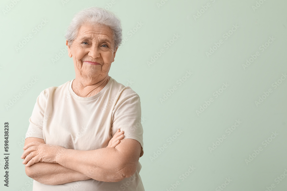 Senior woman on green background