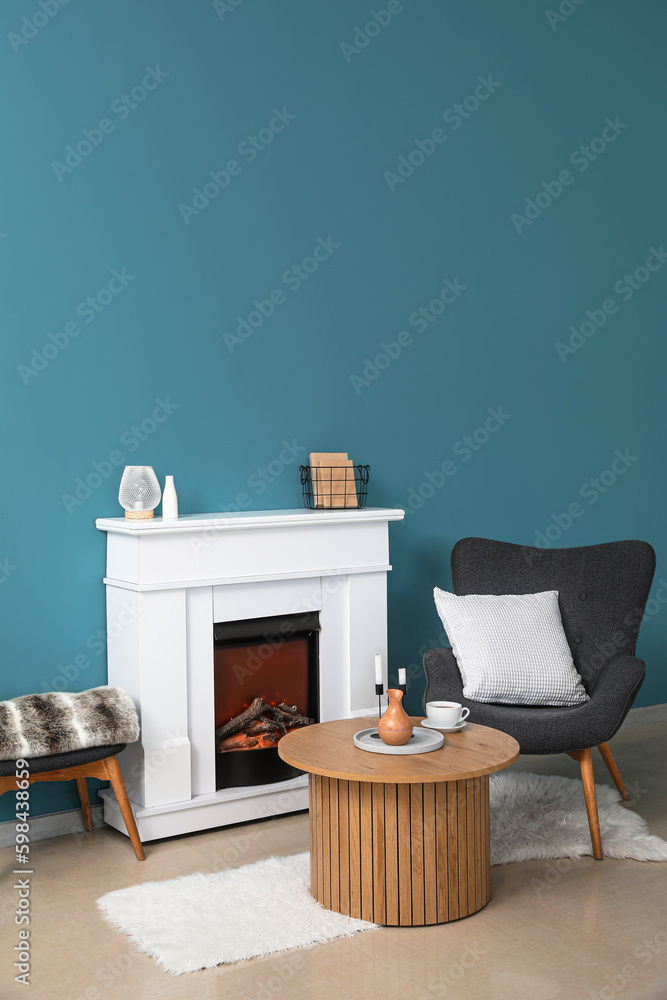 Interior of living room with cozy armchair, fireplace and coffee table