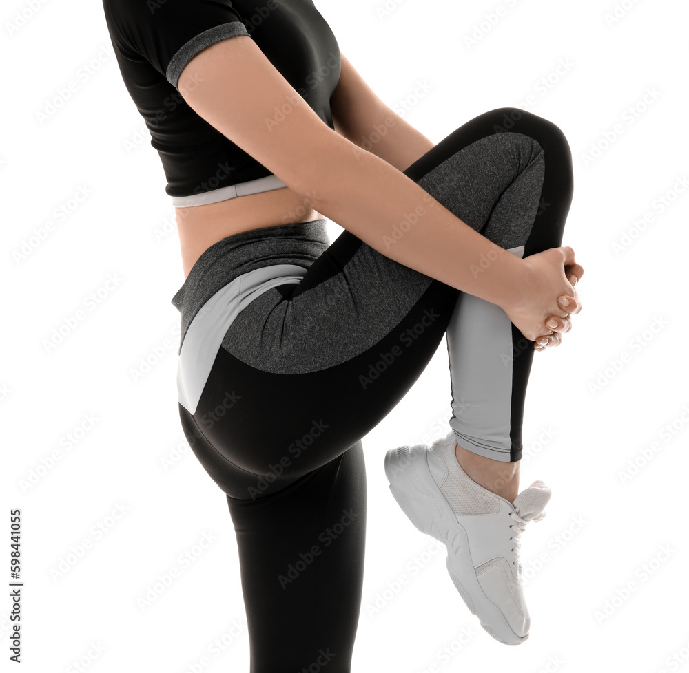 Sporty young woman in leggings on white background